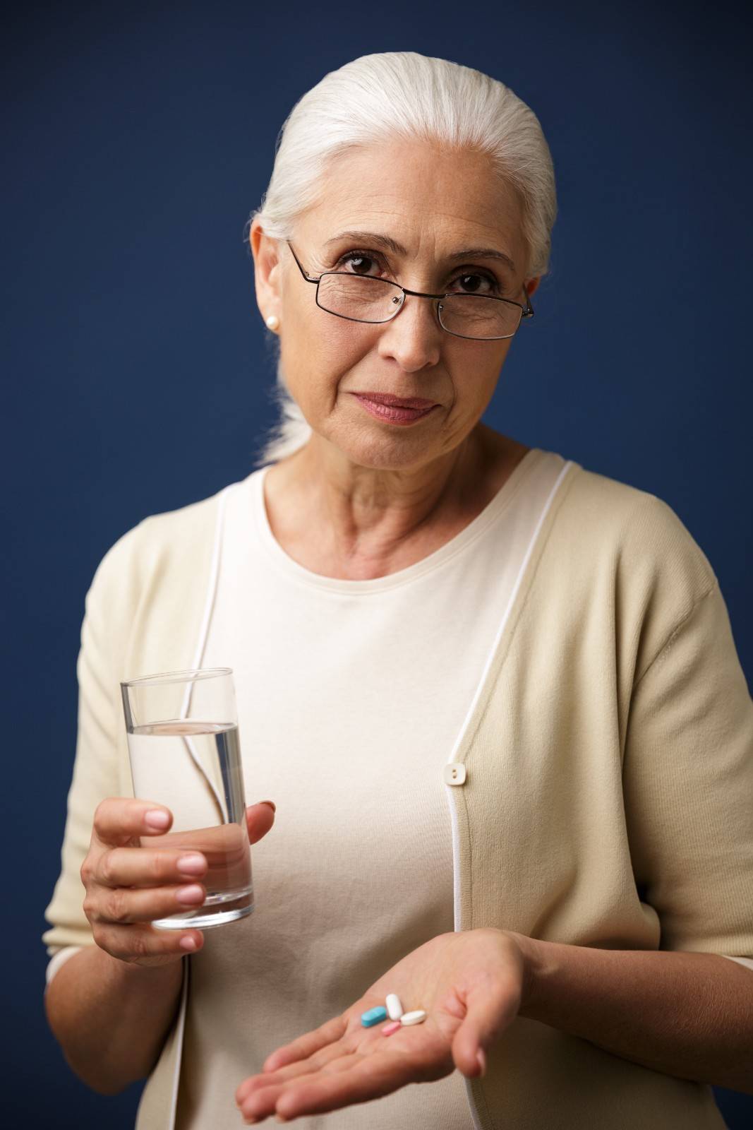serious-woman-holding-pills1